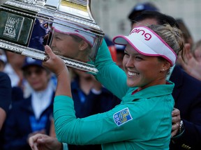 Brooke Henderson of Canada holds the winners trophy after winning the final round of the KPMG Women's PGA Championship at Sahalee Country Club on June 12, 2016 in Sammamish, Washington.  (Photo by Otto Greule Jr/Getty Images)