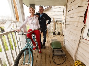 Veronica Wakeham (left) and Robert Hodder pose for a photo with Veronica's bicycle that survived the Fort McMurray wildfires. Hodder says there has been a calm after the wildfires, but some residents are still reaching out for help.