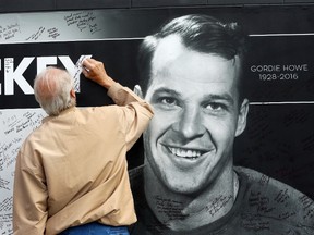 A fan leaves a tribute to Gordie Howe, the man known as Mr. Hockey, outside Joe Louis Arena, the home of the Detroit Red Wings, his team for much of his NHL Hall of Fame career, Tuesday, June 14, 2016 in Detroit. (AP Photo/Carlos Osorio)