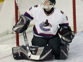 Vancouver Canucks goalie Dan Cloutier watches the puck as it is deflected above the net during NHL action against the Edmonton Oilers at Rexall Place in Edmonton on Saturday, October 8, 2005. (Postmedia Network file photo)