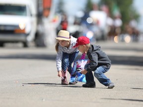 Kids pick up candy from floats during the Pete Knight Days Parade along Railway Street on Saturday, June 11, 2016 in Crossfield, Alta. Britton Ledingham/Airdrie Echo/Postmedia Network