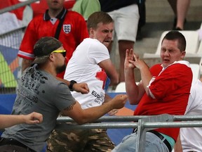 Russian supporters attack an England fan at the end of the Euro 2016 Group B soccer match between England and Russia, at the Velodrome stadium in Marseille, France. (AP Photo/Thanassis Stavrakis, File)