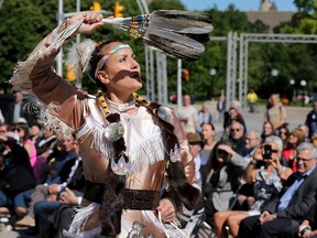 Josee Bourgeois, a jingle dress dancer from Pikwakanagan, performs on the lawn of city hall with four drummers. Julie Oliver/Postmedia