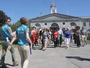 The inaugural tour inside Kingston Penitentiary leaves the main gate of the institution in Kingston on Tuesday. The public tours of the federal prison, which closed in 2013, begin this week and run through October. (Michael Lea/The Whig-Standard)