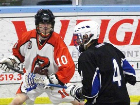 Korey Conroy of the Point Edward Pacers tries to get past Edwin Brown of the London Blue Devils during Ontario Junior B Lacrosse League regular-season action at the Point Edward Arena. Conroy had three goals Monday night against London and now has a team-high 20. (Terry Bridge/Sarnia Observer/Postmedia Network)