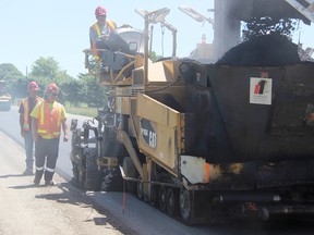 Dust flies as workers with Dufferin Construction add asphalt to Churchill Line, near Fairweather Road Tuesday. Resurfacing on Churchill, between Mandaumin and Marthaville roads, is expected to finish up by this weekend. (Tyler Kula/Sarnia Observer/Postmedia Network)