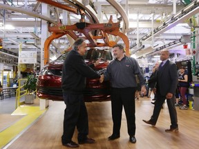 In this Friday, May 6, 2016, file photo, Fiat Chrysler Automobiles Chairman and CEO Sergio Marchionne, left, shakes hands with Dino Chiodo, president of Unifor Local 444 in front of a 2017 Pacifica minivan on the Windsor Assembly Plant line, in Windsor, Ontario.  (AP Photo/Carlos Osorio, File)