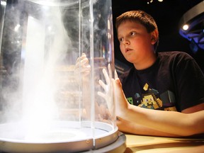 Ethan Henry and classmates from Carl A. Nesbitt Public School experiment with a tornado formation simulator at the world premiere of Wild Weather at Science North in Sudbury, Ont. on Tuesday June 14, 2016. Gino Donato/Sudbury Star/Postmedia Network