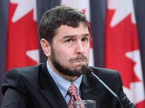 Maher Arar listens to a question at a press conference in Ottawa on Dec. 12, 2006. The RCMP is laying a torture charge against a former Syrian military intelligence officer for alleged involvement in the brutal treatment of Ottawa telecommunications engineer Arar. THE CANADIAN PRESS/Tom Hanson