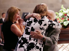 Cathy Howe greets family friend Felix Gatt at the Cathedral of the Most Blessed Sacrament before the funeral for Gordie Howe, Wednesday, June 15, 2016 in Detroit. (AP Photo/Carlos Osorio, Pool)
