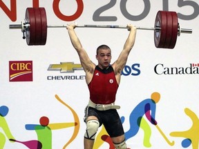 Boady Santavy, pictured lifting 176 kg in the clean and jerk at the 2015 Pan American Games in Toronto, has earned first alternate status for the Canadian Olympic weightlifting team. He was named an alternate for Rio while breaking junior Canadian and Commonwealth records at the Pan-American Championships in Cartagena, Colombia. (Handout)