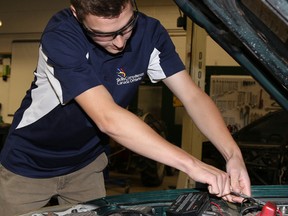 Tim Miller/The Intelligencer
Taylor McGinnis works on a car at Centennial Secondary School on Wednesday. The Grade 12 student recently won silver in a Canada-wide automotive skills competition held in Moncton, New Brunswick.