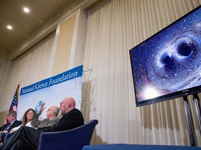 In this Feb. 11, 2016 file photo, from left, Interferometer Gravitational-Wave Observatory (LIGO) Executive Director David Reitze, LIGO Scientific Collaboration spokesperson Gabriela Gonzalez, and Laser Interferometer Gravitational-Wave Observatory (LIGO) co-founders Rainer Weiss and Kip Thorne, appear next to a visual of the first gravitational waves from two converging black holes during a news conference at the National Press Club in Washington. Astronomers say they’ve heard the echoes of yet two more crashing black holes _ a discovery that hints that the unseen violence of the universe may be pretty common.  (AP Photo/Andrew Harnik)
