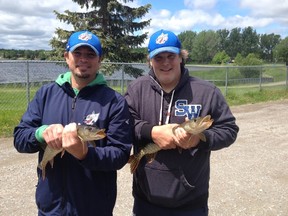 Sudbury Wolves coaches Dave Matsos (left) and Drake Berehowsky show off a pair of Whitewater Lake northern pike after an excursion on the local lake last week. Bruce Heidman/The Sudbury Star