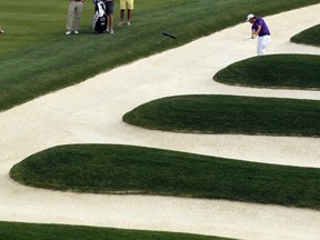Mike Miller hits out of the bunker on the 15th hole during a practice round for the U.S. Open golf championship at Oakmont Country Club in Oakmont, Pa., on June 15, 2016. (AP Photo/Charlie Riedel)