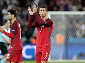 Portugal’s Cristiano Ronaldo applauds supporters at the end of the Euro 2016 match against Iceland at the Geoffroy Guichard Stadium in Saint-Etienne, France, Tuesday, June 14, 2016. (AP Photo/Pavel Golovkin)