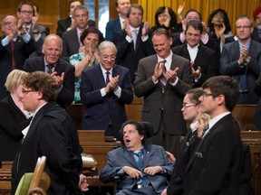 Mauril Belanger receives a standing ovation during a vote on his private member's bill to make the national anthem more gender neutral, in the House of Commons on Parliament Hill on Wednesday, June 15, 2016 in Ottawa. THE CANADIAN PRESS/Justin Tang