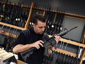 An employee checks the chamber of an assault-style rifle at the RTSP shooting range in New Jersey on December 9, 2015. AFP Photo/JEWEL SAMAD