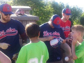 Members of the Kingston Ponies (left to right) Graeme Fox, Ross Graham and Ryan Abraham sign autographs for children at Lake Ontario Park on Wednesday while visiting with Boys and Girls Club of Kingston baseball enthusiasts.
