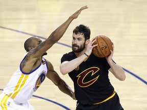 Kevin Love of the Cleveland Cavaliers handles the ball against Andre Iguodala of the Golden State Warriors during the second half in Game 5 of the NBA Finals at ORACLE Arena in Oakland on June 13, 2016. (Ronald Martinez/Getty Images/AFP)