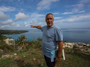 In this June 10, 2016 photo, Guy Chartier, president of Wilton Properties Ltd. and project head of Montreal-based developer 360 VOX, shows the land where luxury hotels and a golf course are projected to be built in Jibacoa, Cuba. Twenty years ago the Canadian developer won the right to build golf courses and condominiums, but year after year the plan failed to materialize. Then, the U.S. and Cuba declared detente, and now the developer says it's preparing to break ground. (AP Photo/Desmond Boylan)