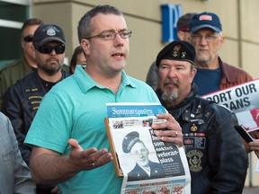 Peter Blendheim, son of Norwegian veteran Petter Blindheim, holding a recent newspaper from Norway, protests with members of the advocacy group Banished Veterans outside the Veterans Affairs office in Halifax on Thursday, June 16, 2016. The group is protesting a decision to deny the decorated 94-year-old war veteran entry into the federally funded Camp Hill Veterans Memorial Hospital. THE CANADIAN PRESS/Andrew Vaughan