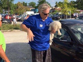 Mark Lewis with the dog he rescued from a locked car near the Grand Bend beach June 4. A video of the rescue, in which the Huron County man used a rock to break the vehicle’s window, has gone viral with approximately 600,000 views as of Wednesday. Lewis said Wednesday he was initially worried about the damage he had caused, but now has no regrets. “It was all about the dog.” The animal was returned to its owners. The incident is being investigated by Lambton OPP and the OSPCA.
(Contributed photo)