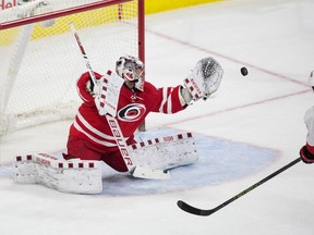 Carolina Hurricanes goalie Cam Ward, left, makes a save on a shot by Ottawa Senators’ Zack Smith (15) in the shootout of a game in Raleigh, N.C., Tuesday, March 8, 2016. (AP Photo/Ben McKeown)