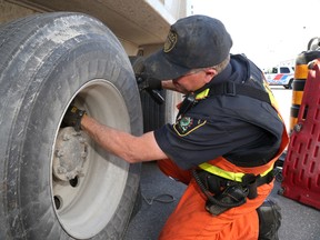 Jason Miller/The Intelligencer
Michael Kerr, transportation ministry enforcement officer, inspects a dump truck to see if it is in compliance with provincial regulations.