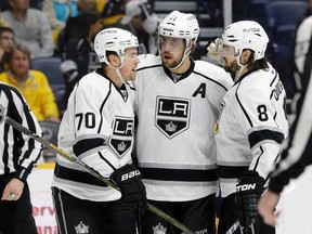 Los Angeles Kings left wing Tanner Pearson (70), centre Anze Kopitar (11) and defenceman Drew Doughty celebrate after the Kings scored against the Nashville Predators Monday, March 21, 2016, in Nashville, Tenn. (AP Photo/Mark Humphrey)