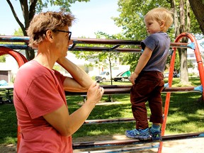 Skeleton Park Arts Festival organizer Greg Tilson with his son George at McBurney Park in Kingston. (Julia Balakrishnan for the Whig-Standard/Postmedia Network