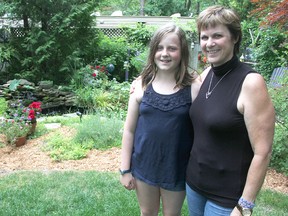 Lauren Morrison and Shirley Morris pose in Morris' garden in Sarnia. They're hosting a garden tour Saturday to help raise funds to build a school in Kenya. (Tyler Kula/Sarnia Observer/Postmedia Network)