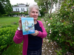 Artist Sarah Cowling, an historical interpreter at Eldon House, displays her Alice art in the garden of Eldon House. Cowling is among artists participating in Sunday?s show and sale. (MORRIS LAMONT, The London Free Press)