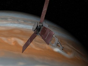 This artist's rendering made available by NASA/JPL-Caltech on July 7, 2015 shows the Juno spacecraft above Jupiter. The spacecraft is scheduled to arrive at the planet on July 4, 2016 to begin a nearly year-long study of the gas giant. (NASA/JPL-Caltech via AP)