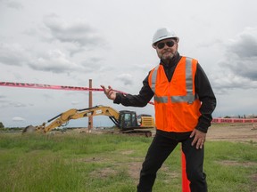 Councillor Tony Caterina, ducks under the construction tape at the $186 million, 500,000 square foot Transit Garage near Fort Road.