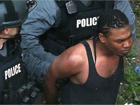 Kurlan Lawrence following arrest in July 2015 (Tony Caldwell, Postmedia)