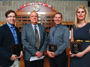 The 2016 Queen’s University Faculty of Education Associate Teachers of the Year recipients included Limestone teachers Andrew Cotton from Central Public School, left, Rob Switzer from Loyalist Collegiate and Rebecca Andrew from R. G Sinclair Public School, who pose for a photo with Alan Wilkinson from Queen's University, in grey jacket, at the Limestone District School Board June meeting in Kingston on Wednesday. (Julia McKay/The Whig-Standard)