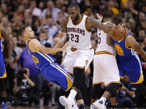 Cleveland Cavaliers forward LeBron James and Golden State Warriors guard Stephen Curry collide during the first half of Game 6 of the NBA Finals in Cleveland on June 16, 2016. (AP Photo/Tony Dejak)
