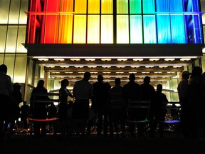 Patrons pay their respects at a memorial at the Dr. Phillips Center for the Performing Arts Thursday, June 16, 2016 in Orlando, Fla. The city and nation is still feeling the effects of the June 12 mass shooting in an Orlando nightclub – Pulse. (Corey Perrine/Naples Daily News via AP)