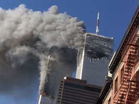 In this Sept. 11, 2001 file photo, smoke rising from the burning twin towers of the World Trade Center after hijacked planes crashed into the towers, in New York City.  (AP Photo/Richard Drew, File)
