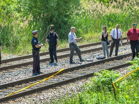 Investigators at the scene of a police-involved shooting along train tracks,  southeast of Weston Rd and Sheppard Ave W. -  where the SIU has invoked it's mandate in Toronto, Ont.  on Friday June 17, 2016. Ernest Doroszuk/Toronto Sun/Postmedia Network