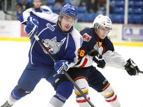 Sudbury Wolves defenceman Jeff Corbett fights for position with Andrew Mangiapane of the Barrie Colts during OHL action at Sudbury Community Arena on Jan. 26, 2014. Gino Donato/The Sudbury Star/QMI Agency