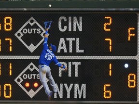 Jose Bautista of the Toronto Blue Jays jumps for a fly ball but is unable to make the catch in the seventh inning against the Philadelphia Phillies at Citizens Bank Park in Philadelphia on June 16, 2016. (Drew Hallowell/Getty Images/AFP)