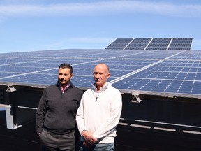 Del Ridge Homes principals George Le Donne and Dave De Sylva in front of solar array similar to what will be installed on the GEM condo in Markham.