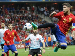 Spain's Sergio Ramos reaches for the ball a Euro 2016 Group D soccer match between Spain and Turkey at the Allianz Riviera stadium in Nice, France, on June 17, 2016. (AP Photo/Claude Paris)