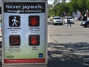 Anti-jaywalking sign recently installed on Whyte Avenue near 101 Street, a location where two people have been killed recently crossing the road legally in the crosswalk in Edmonton, June 17, 2016.