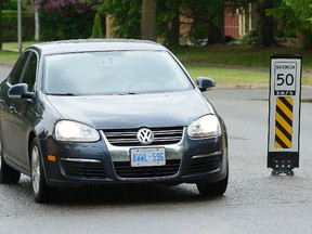 A new speed limit sign in the middle of Glenora Drive in north London is one of 12 in a pilot project to test their effect on drivers. (MORRIS LAMONT, The London Free Press)