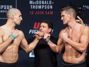 Rory MacDonald (left) and Stephen Thompson get in the traditional battle stance during the weigh-in for UFC Fight Night 89. (The Canadian Press)