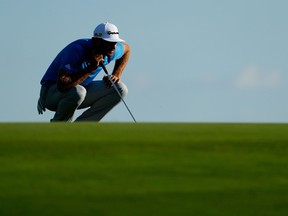 Dustin Johnson of the United States lines up a putt on the third green during the second round of the U.S. Open at Oakmont Country Club in Oakmont, Pa., on June 17, 2016. (Christian Petersen/Getty Images/AFP)