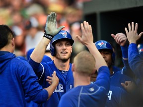 Toronto Blue Jays' Michael Saunders is congratulated after hitting a three-run home run against the Baltimore Orioles in the first inning of a game in Baltimore on June 17, 2016. (AP Photo/Gail Burton)
